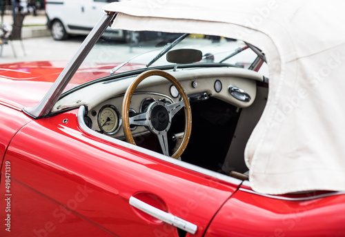 Photo of a car's inside. Woodened wheel © Bedo
