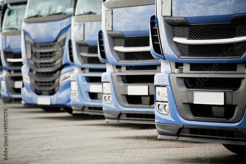 Obraz na plátně Fleet of commercial lorry trucks in row