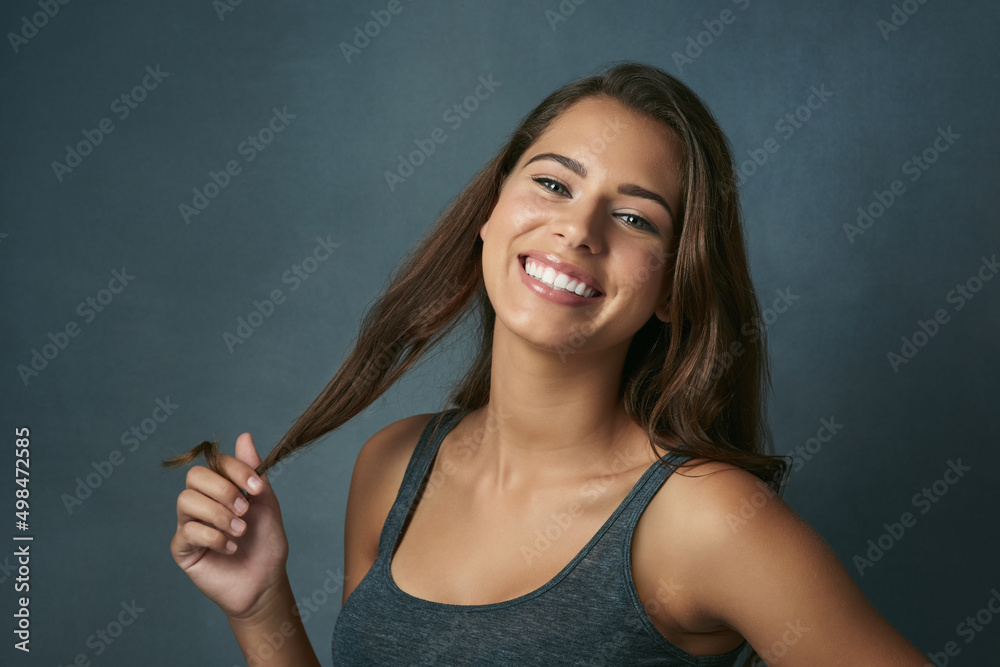 Natural beauty is the best beauty. Studio shot of a beautiful young woman posing against a blue background. Natural beauty is the best beauty. Studio shot of a beautiful young woman posing against a blue background.