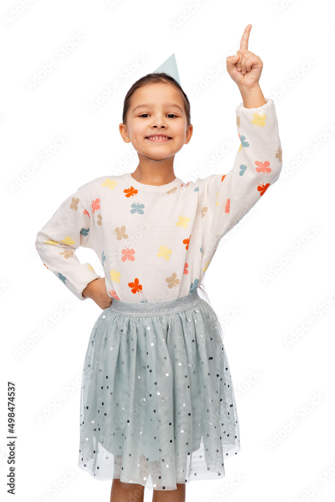 birthday, childhood and people concept - portrait of smiling little girl in party hat pointing finger up over white background birthday, childhood and people concept - portrait of smiling little girl in party hat pointing finger up over white background