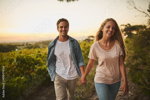 It feels like we started yesterday. Shot of a young couple walking through their crops and holding hands while smiling all the way.