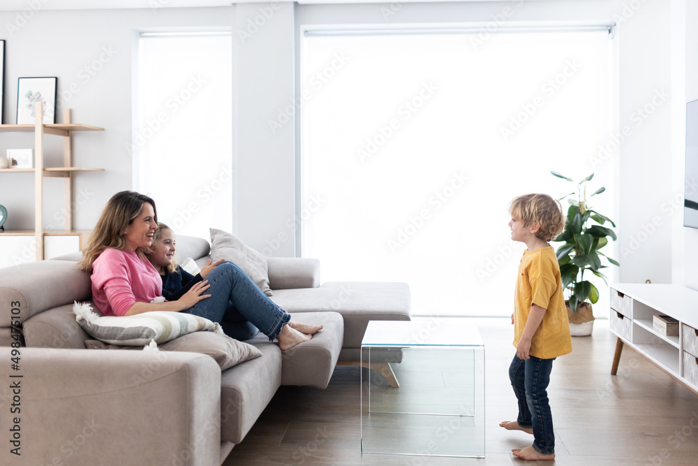 Boy gesticulating while playing with mother and sister Boy gesticulating while playing with mother and sister