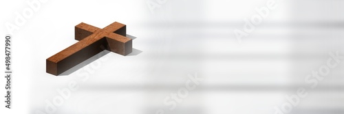 Close up view of wooden cross against white background with copy space