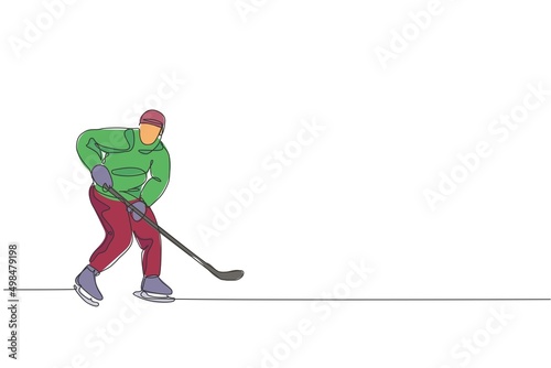 Single continuous line drawing of young professional ice hockey player hit the puck and attack on ice rink arena. Extreme winter sport concept. Trendy one line draw design graphic vector illustration