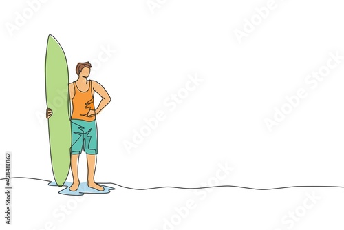 One single line drawing of young sporty surfer man standing and holding long surfing board at sandy beach graphic vector illustration. Extreme water sport concept. Modern continuous line draw design