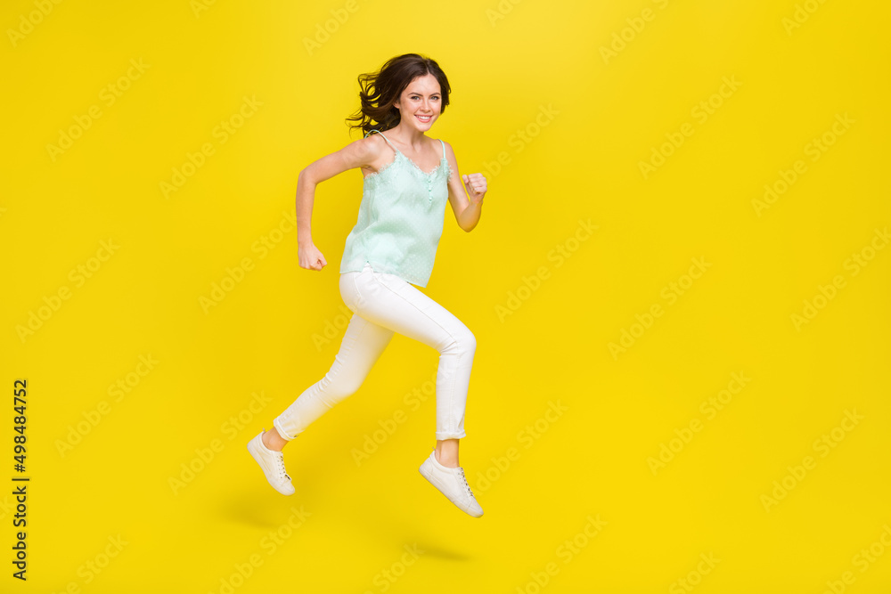 Full length photo of cheerful female go on vacation enjoy summer vacation traveling isolated on yellow color background