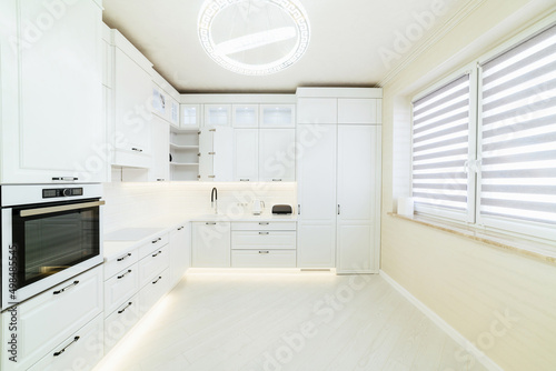 bright interior of a new kitchen in a house with windows