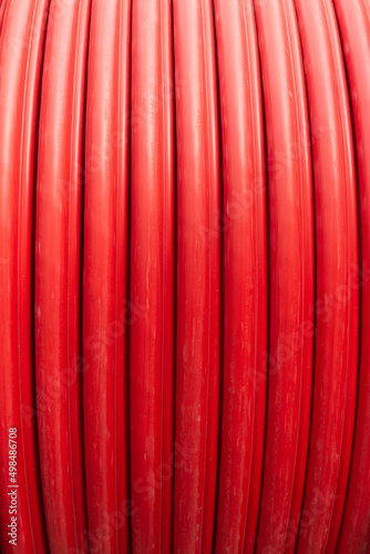Red wire cable in reels close up on coil