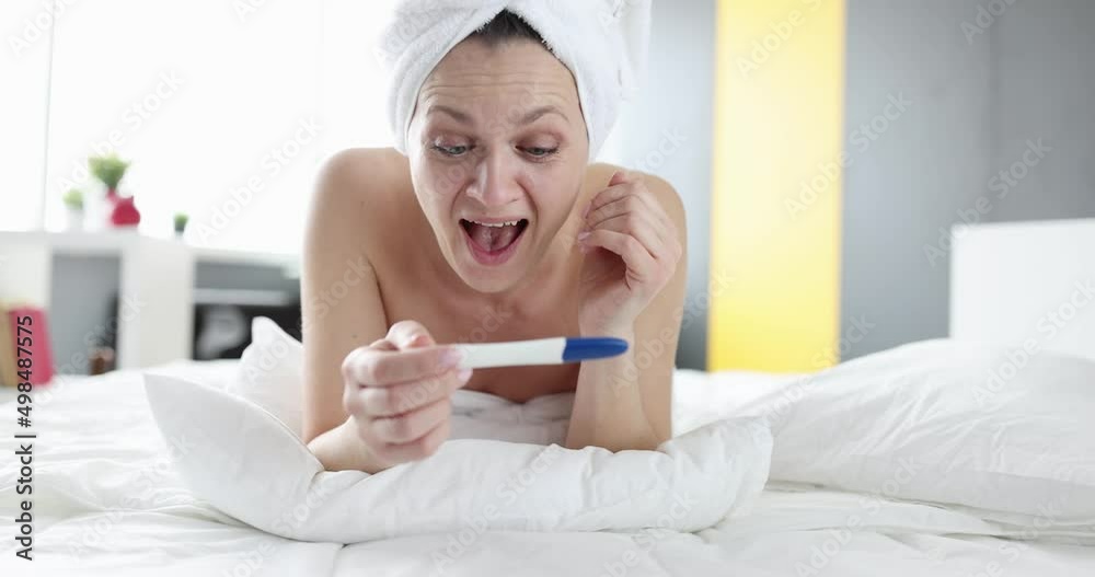 Joyful woman holding positive pregnancy test Joyful woman holding positive pregnancy test