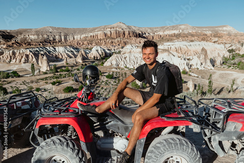Young Caucasian Male Tourist in Cappadocia Turkey on a group tour with a red ATV