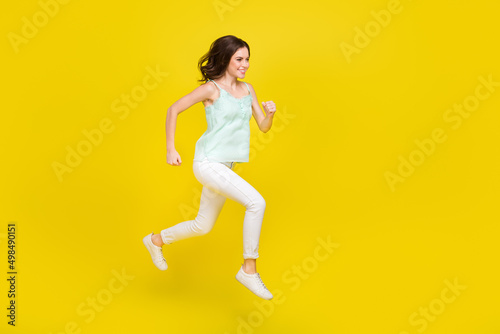 Full body profile side photo of cheerful good mood woman traveling summer season isolated on yellow color background