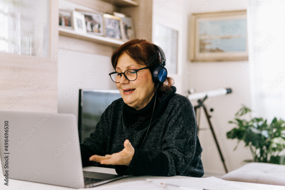 Middle aged woman works remotely from home - older mature people and technology concept. Middle aged woman works remotely from home - older mature people and technology concept.