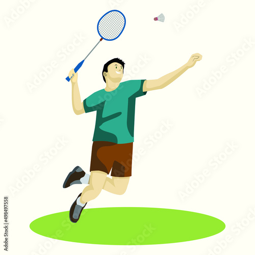 A man in a T-shirt and shorts in a jump hits a shuttlecock with a racket, plays badminton