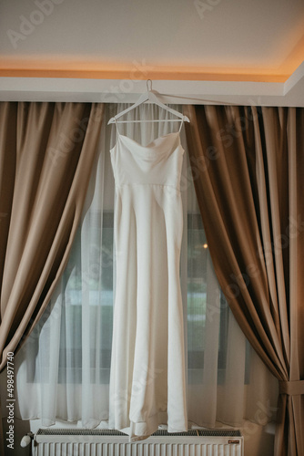 Fashionable beautiful classic dress hanging on hanger.