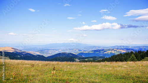 Visually Attractive View of Summer Countryside Mountain Nature Landscape. Picturesque Scenery Green Hills And Fields. Beautiful Blue Sky With Clouds. Mountain Kopaonik, Serbia, Europe.
