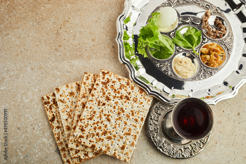 Passover Seder plate with traditional food ontravertine stone background photo