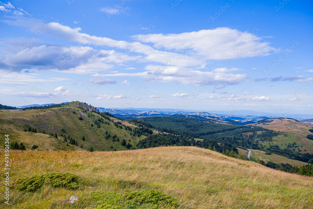 Naklejka premium Summer Countryside Mountain Nature Landscape. Picturesque Scenery Green Hills And Fields. Beautiful Blue Sky With Clouds. Visually attractive View Of Mountain Kopaonik, Serbia, Europe.