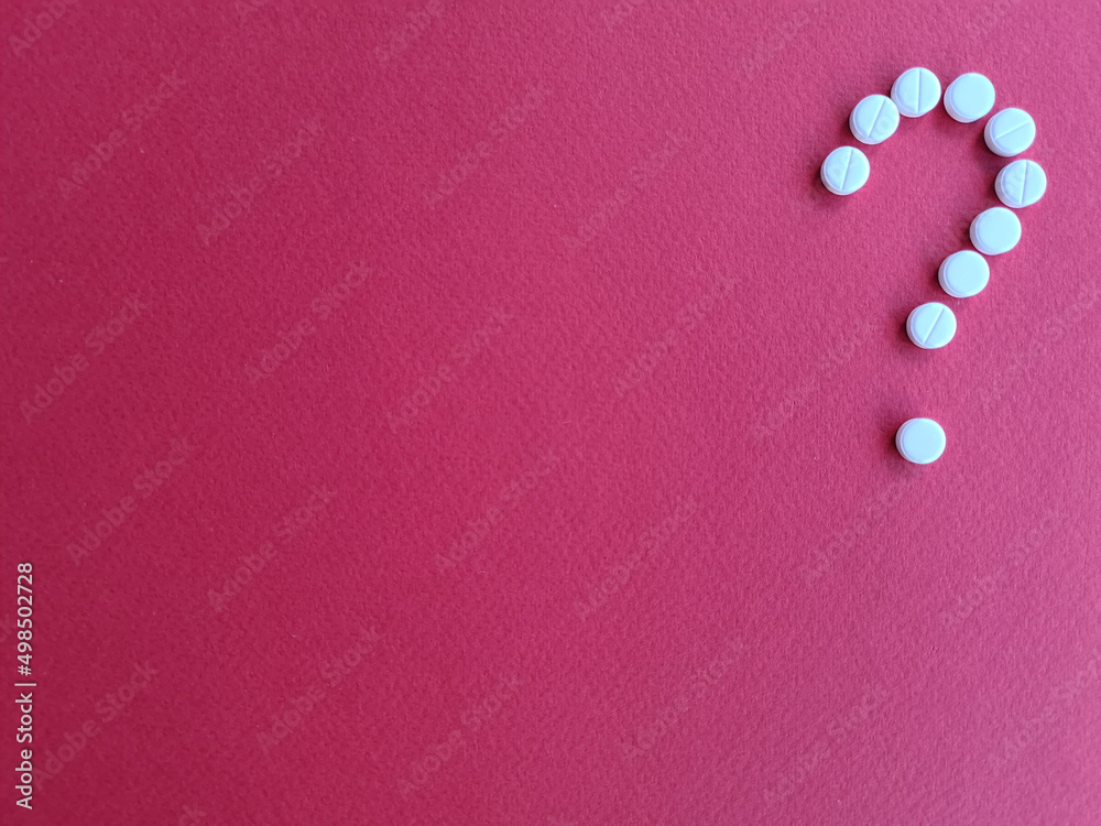 Question mark made from medical pills on red background copy space Question mark made from medical pills on red background copy space