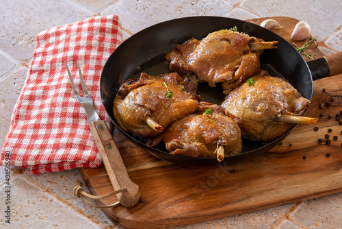 duck confit cooked in a dish photo