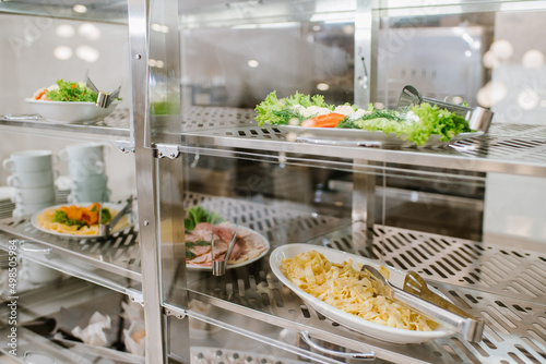 Fototapeta kuchenna Different types of dishes in containers on the buffet table in the hotel restaurant