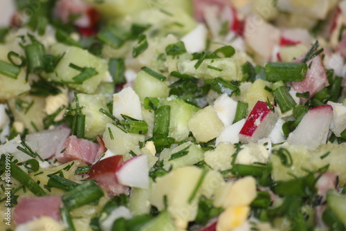 cut ingredients mix for olivie salad or okroshka soup close up photo