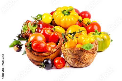 Assorted tomatoes and vegetables isolated on white background. Photo for your design.