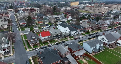 Homes in Hershey PA, USA. American town aerial establishing shot of 1900s multifamily two story homes along street. Neighborhood community residential district drone shot.