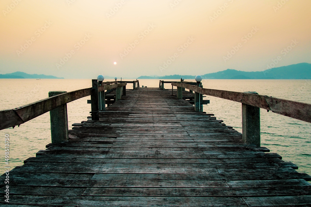 A wooden walkway that stretches into the sea. vacation travel concept. long wooden bridge in the sea