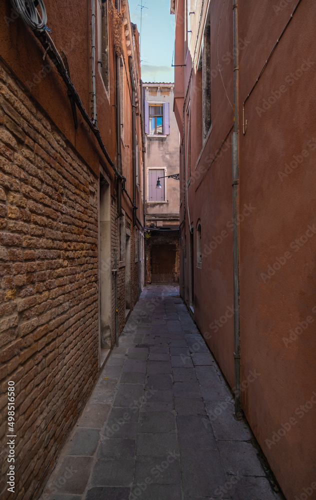 View of historic houses in narrow alley in Venice, Italy
