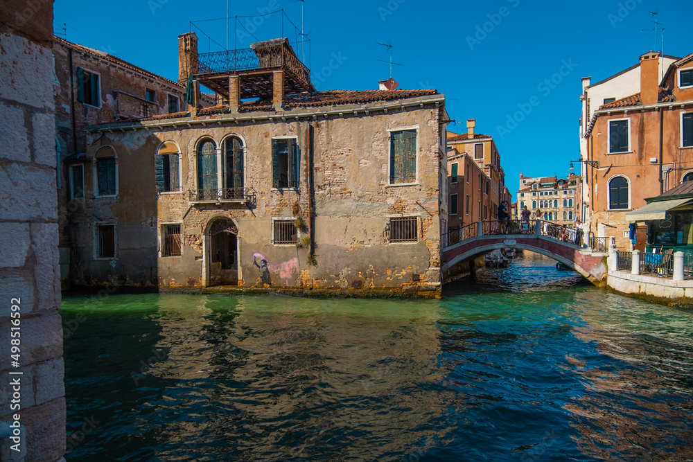VENICE, ITALY - August 27, 2021:  View of people crossing the bridge over the beautiful canals of Venice