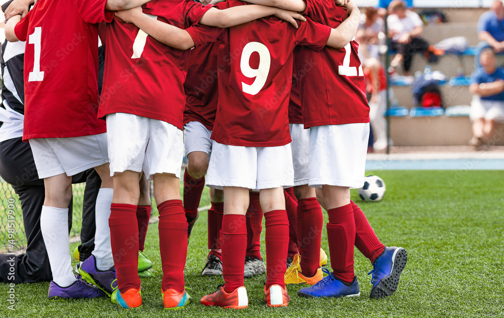 Football Team Standing in Team Circle Before Tournament Final Match. School Soccer Players in Red Soccer Jersey Uniforms. Sports Kids on Briefing With Coach Football Team Standing in Team Circle Before Tournament Final Match. School Soccer Players in Red Soccer Jersey Uniforms. Sports Kids on Briefing With Coach