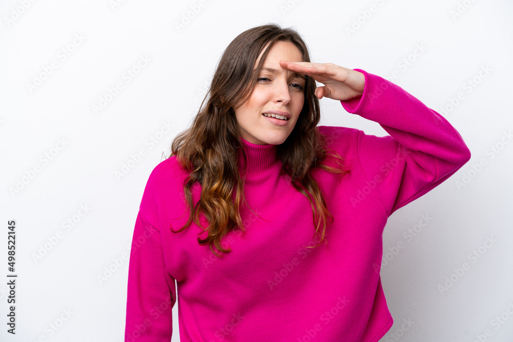 Young caucasian woman isolated on white background looking far away with hand to look something Young caucasian woman isolated on white background looking far away with hand to look something