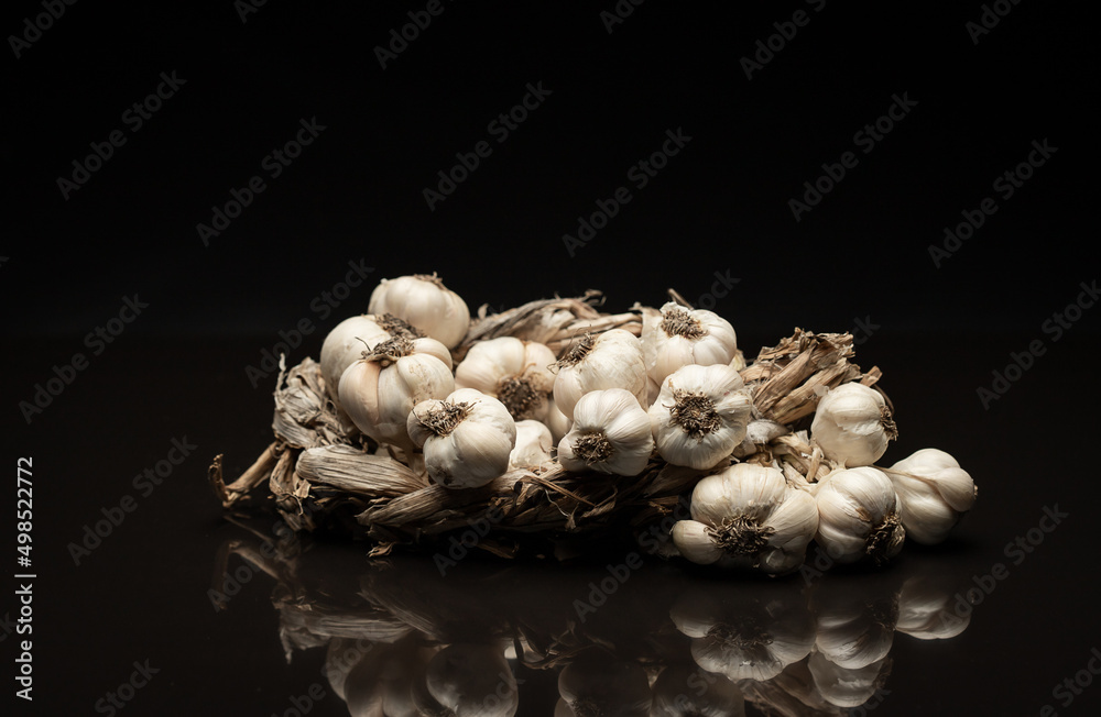 Fragrant Garlic wreath lies on dark background. Agriculture and farming Fragrant Garlic wreath lies on dark background. Agriculture and farming