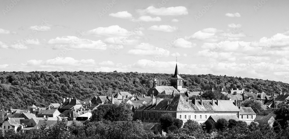 France country travel. Scenic view of Flavigny-sur-Ozerain medieval village in Burgundy  listed as one of France's most beautiful villages. Landscape background. Black white historic photo.