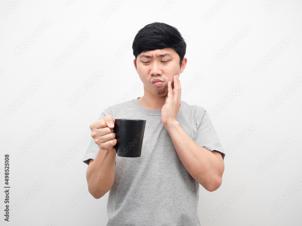 Man grey shirt looking coffee cup gesture toothache unhealth concept Man grey shirt looking coffee cup gesture toothache unhealth concept