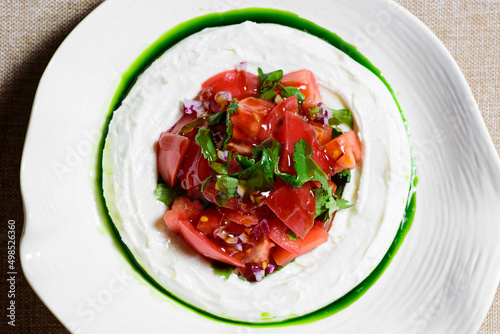 Tomato salad with cheese and mustard-garlic dressing. Tomato salad. top view