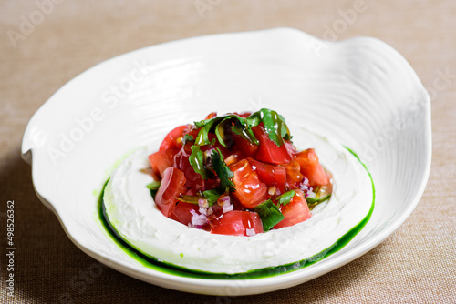 Tomato salad with cheese and mustard-garlic dressing. Tomato salad