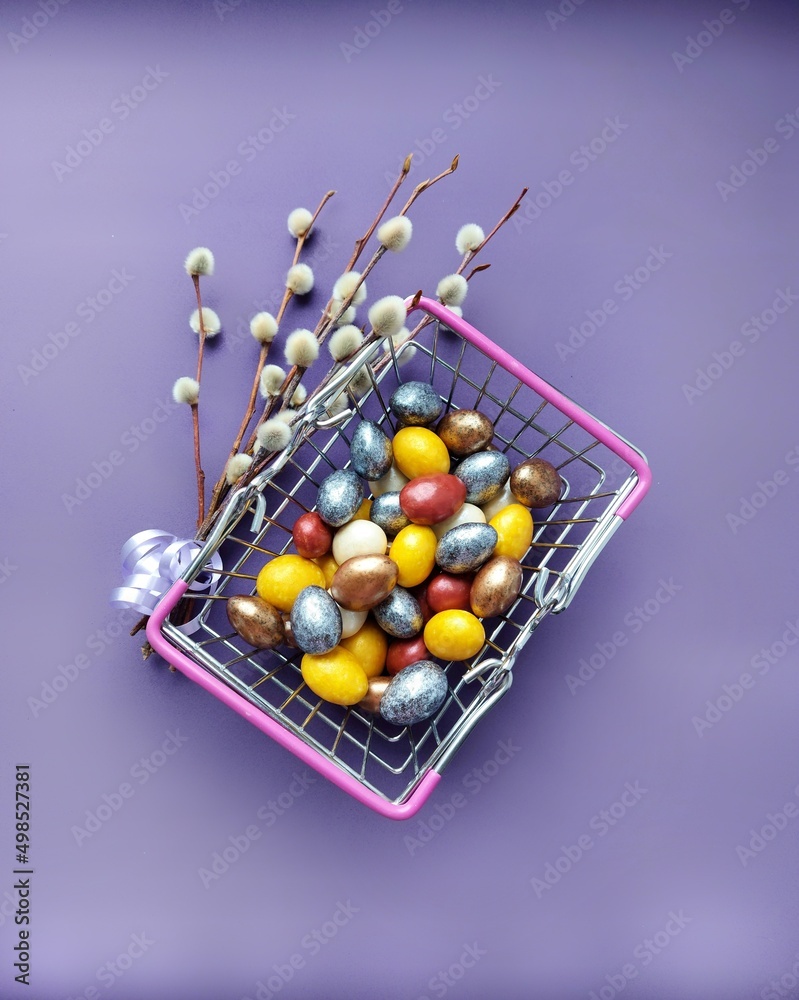 Willow branch, lilac ribbon. Easter eggs. Shopping cart.Happy Easter. Religious holiday.Decoration of eggs. Quail eggs. Willow branch, lilac ribbon. Easter eggs. Shopping cart.Happy Easter. Religious holiday.Decoration of eggs. Quail eggs.