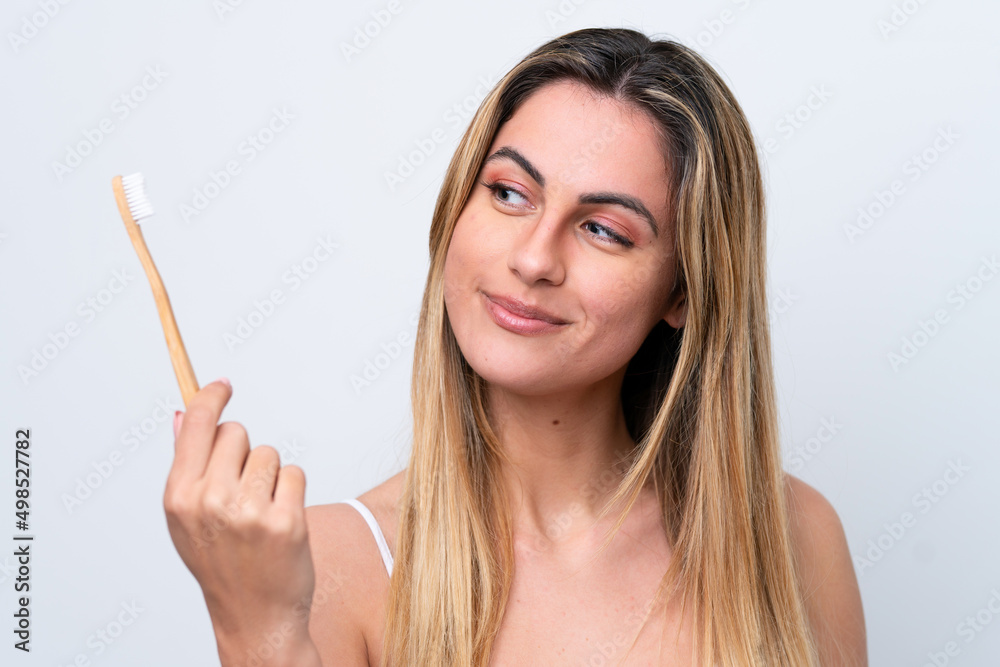 Young caucasian woman isolated on white background with a toothbrush Young caucasian woman isolated on white background with a toothbrush