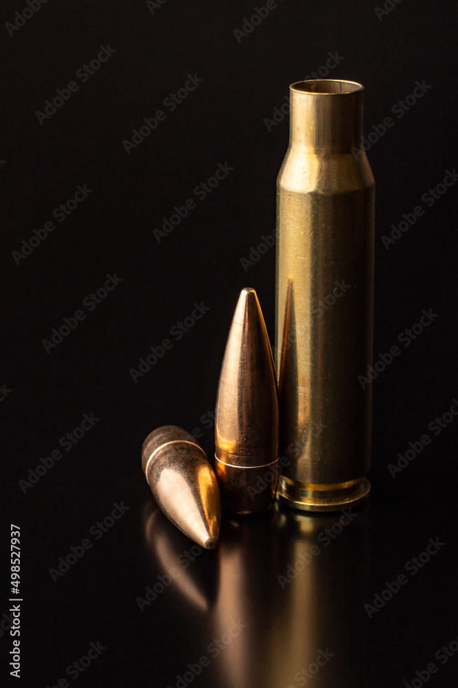 Bullet isolated on black background with reflexion. Rifle bullets close-up on black Bullet isolated on black background with reflexion. Rifle bullets close-up on black