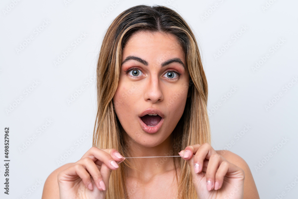 Young caucasian woman isolated on white background with dental floss. Close up portrait Young caucasian woman isolated on white background with dental floss. Close up portrait