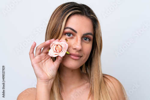 Young caucasian woman isolated on white background holding flowers. Close up portrait