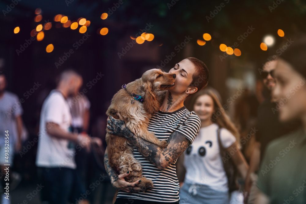 Modern tattooed girl walking with her Cocker Spaniel puppy