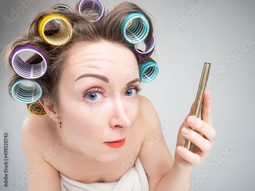 Funny woman with curlers. G...