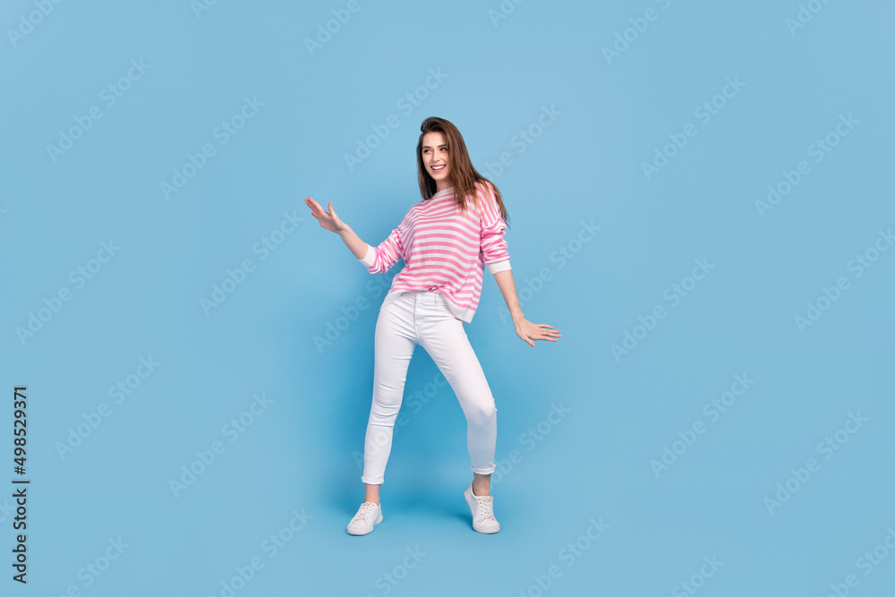 Full body photo of excited satisfied lady partying dancing spend free time isolated on blue color background Full body photo of excited satisfied lady partying dancing spend free time isolated on blue color background