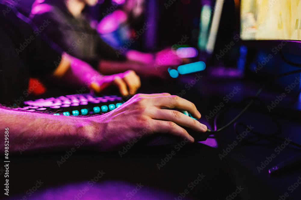 Fototapeta premium Close up of gamer's hand using a computer mouse.