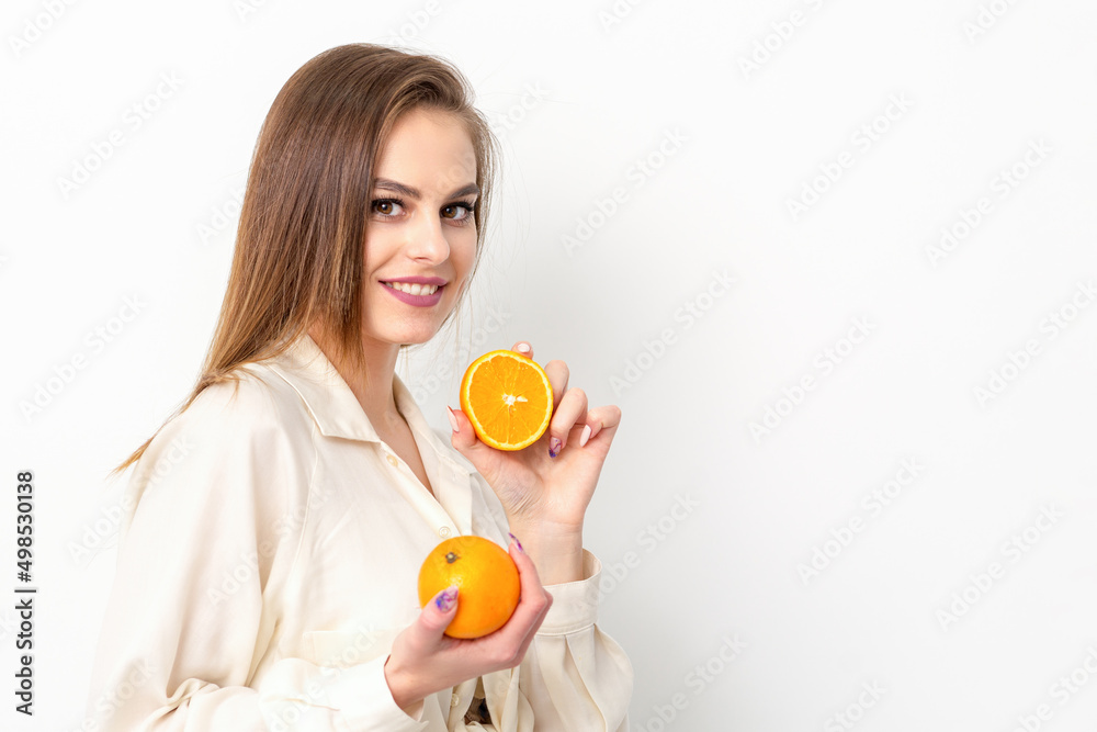 Young Caucasian smiling woman with slices orange over isolated white background Young Caucasian smiling woman with slices orange over isolated white background