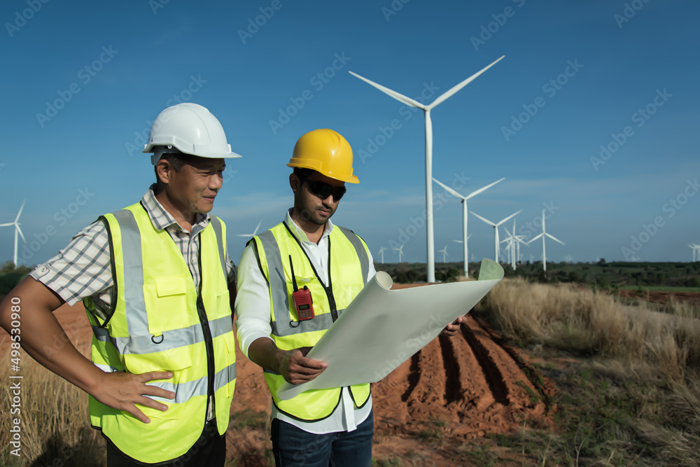 portrait of a worker. Two maintenance planning discuss Project in wind turbine farm. portrait of a worker. Two maintenance planning discuss Project in wind turbine farm.