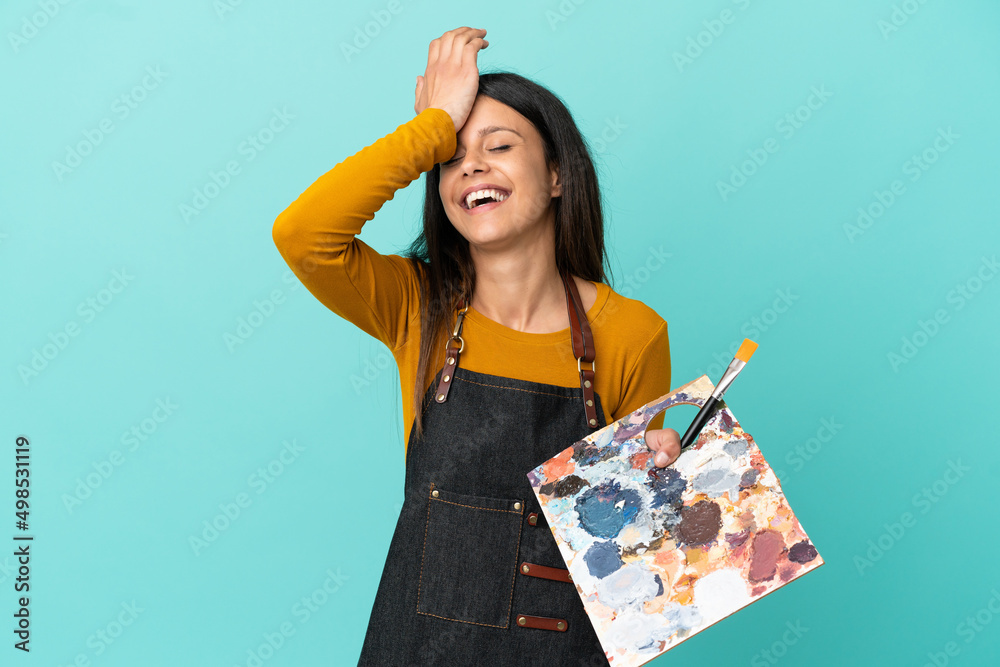 Young artist caucasian woman holding a palette isolated on blue background has realized something and intending the solution Young artist caucasian woman holding a palette isolated on blue background has realized something and intending the solution