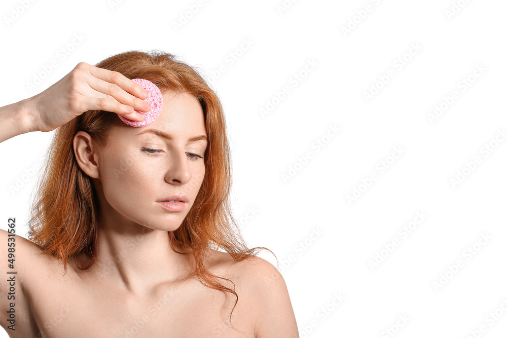 Beautiful woman with makeup sponge on white background Beautiful woman with makeup sponge on white background